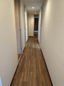 施工後の廊下、フロアタイルに張り替えられた美しい床と壁紙